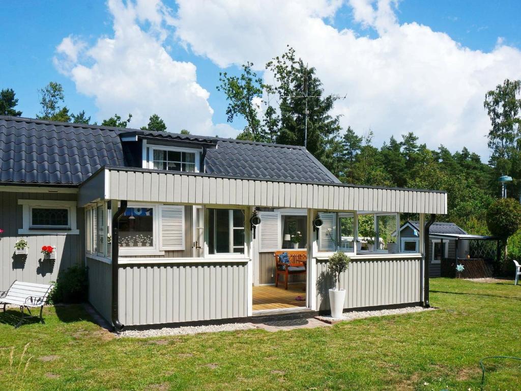 a house with a white fence and a yard at 6 person holiday home in L derup in Löderup
