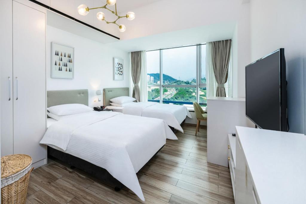 Postel nebo postele na pokoji v ubytování Golden Central Hotel Serviced Residence-Xin Hao E Du金中环服务公寓新浩e都店