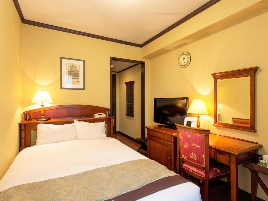 Postel nebo postele na pokoji v ubytování Hotel Monterey Osaka