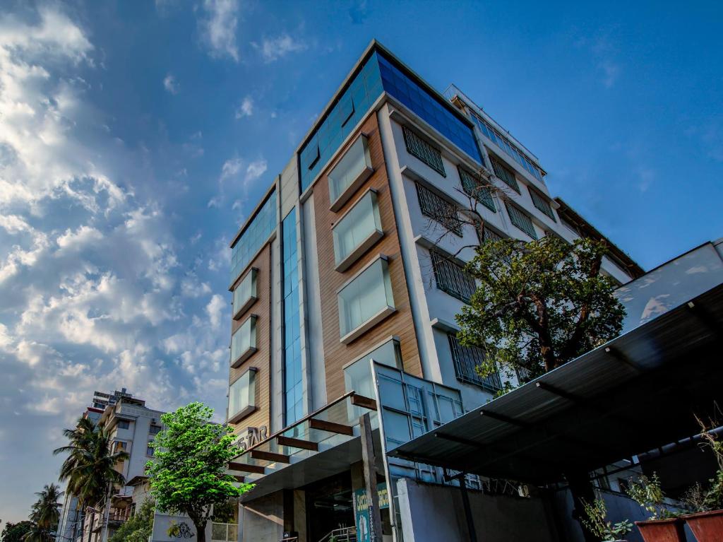 a tall building with glass windows on the side of it at MySpace Hotels Silverstar in Bangalore