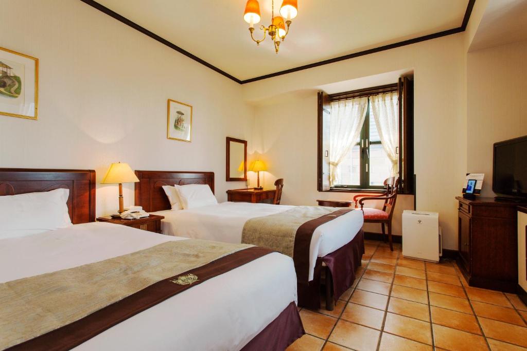 Postel nebo postele na pokoji v ubytování Hotel Monterey Osaka