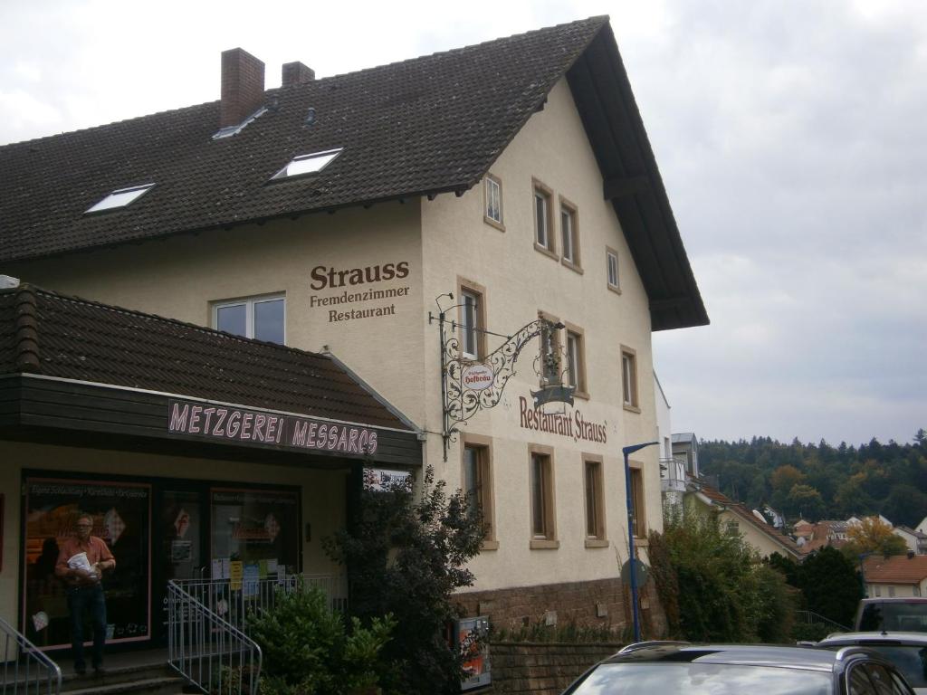 a building with a sign on the side of it at Hotel Strauss in Waldbronn