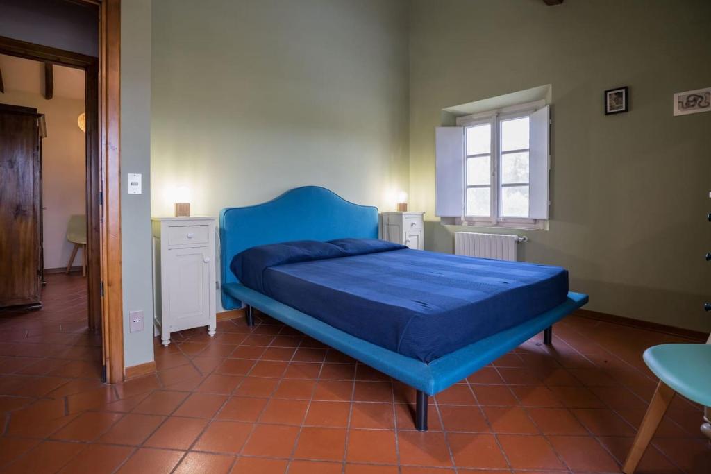 Posteľ alebo postele v izbe v ubytovaní Casale rinnovato immerso nella campagna con splendida piscina privata