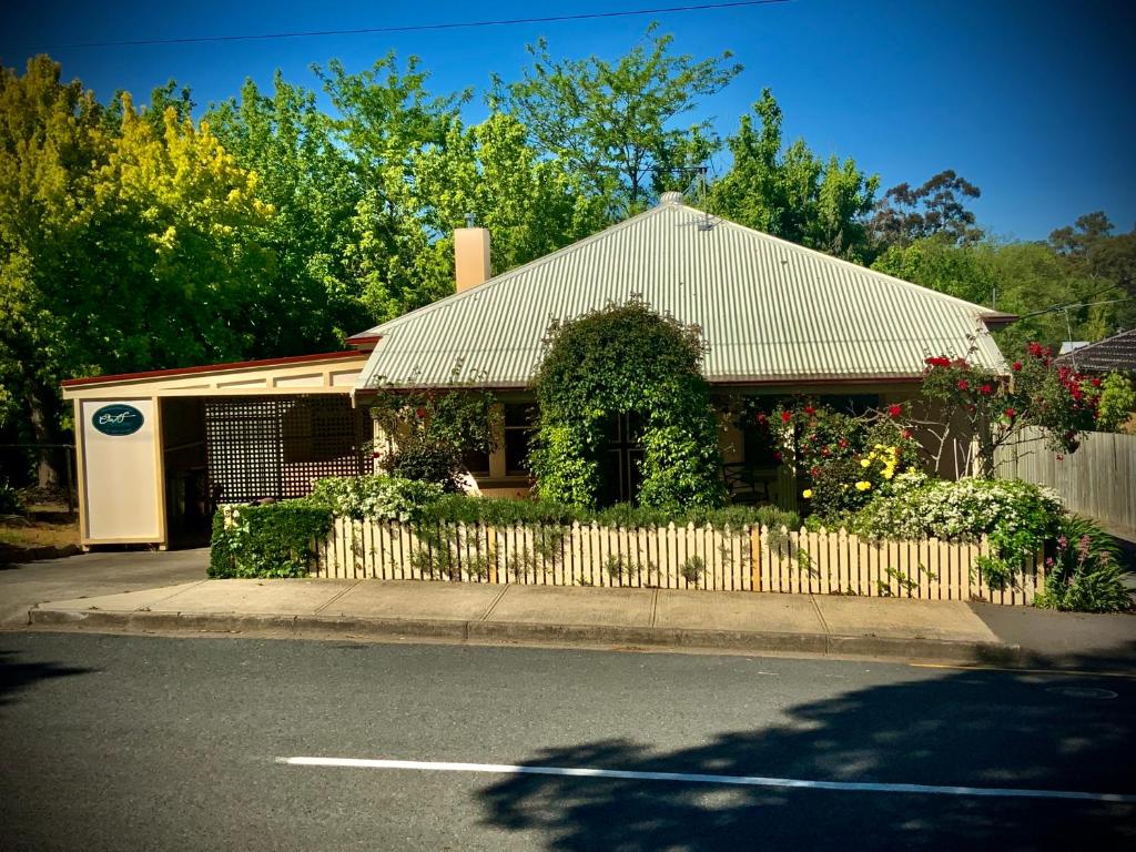 a house on the side of a street with a fence at Oats Cottage in Hahndorf