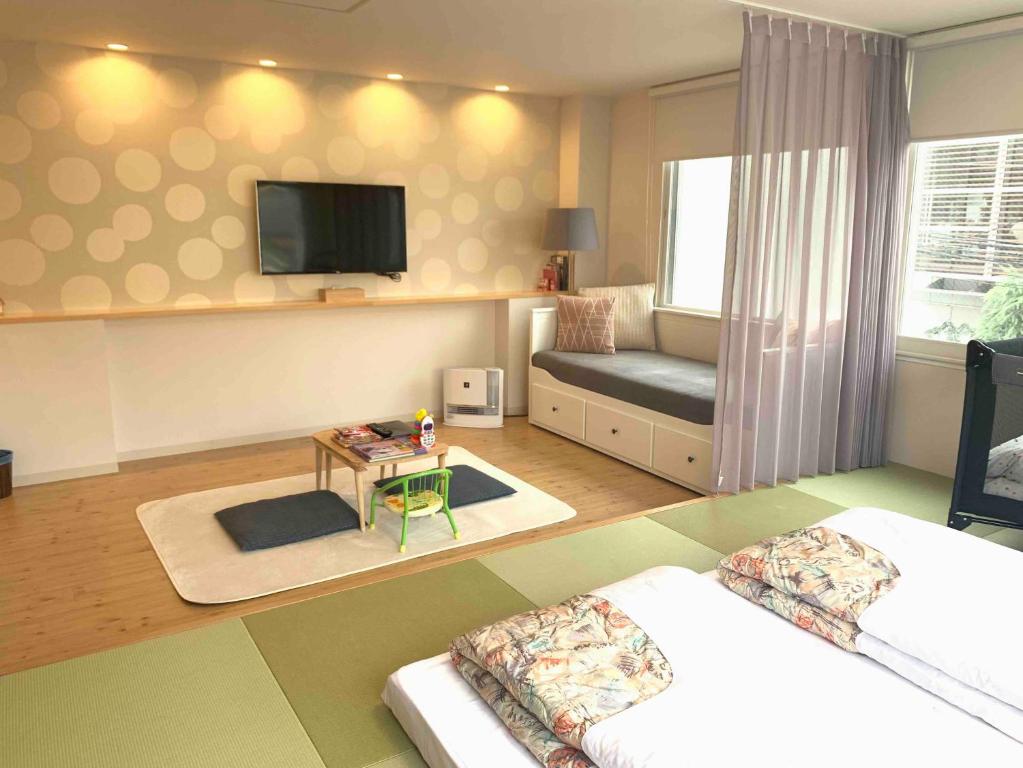 Postel nebo postele na pokoji v ubytování TEN APARTMENT HOTEL