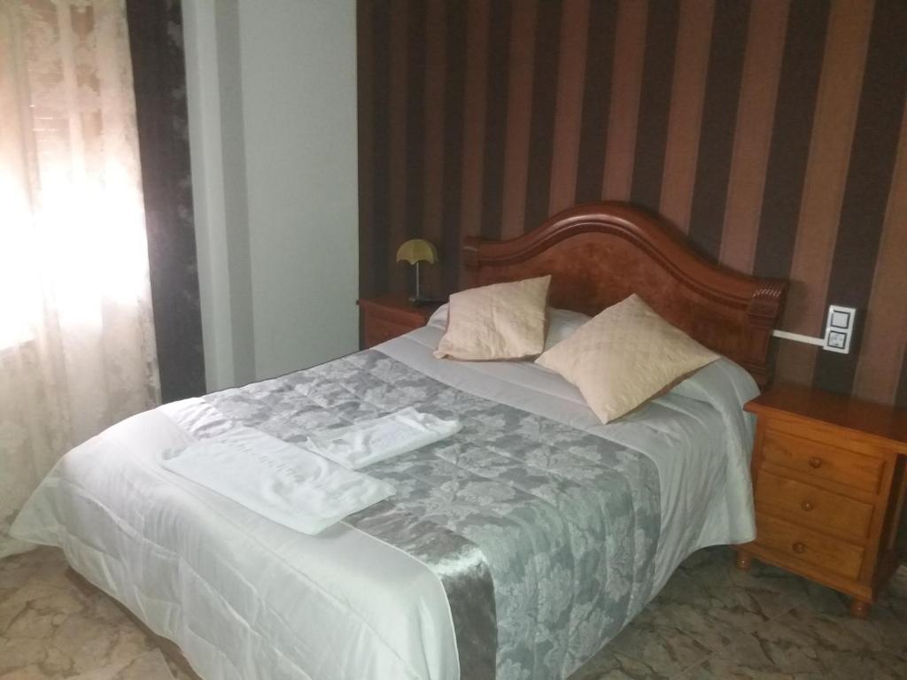 Postel nebo postele na pokoji v ubytování Hostal Texas 2