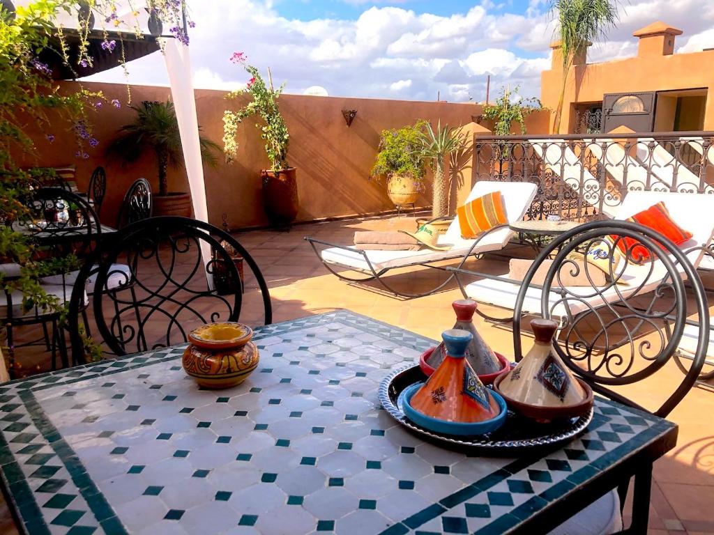 a table with vases on it on a patio at Marrakech - Riad Zouaki in Marrakesh