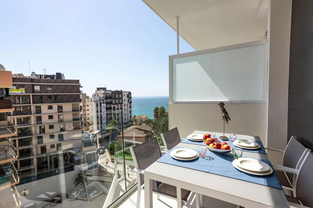 a table with a bowl of fruit on top of a balcony at Calpe Beach in Calpe