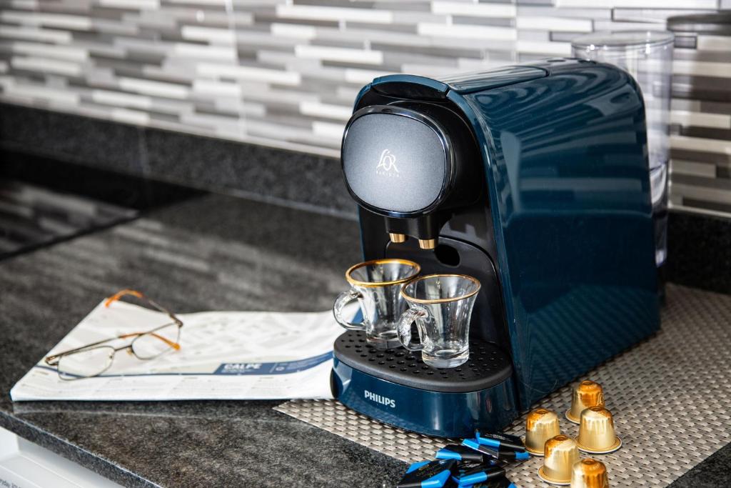 a coffee maker sitting on a counter with two cups at Calpe Beach in Calpe