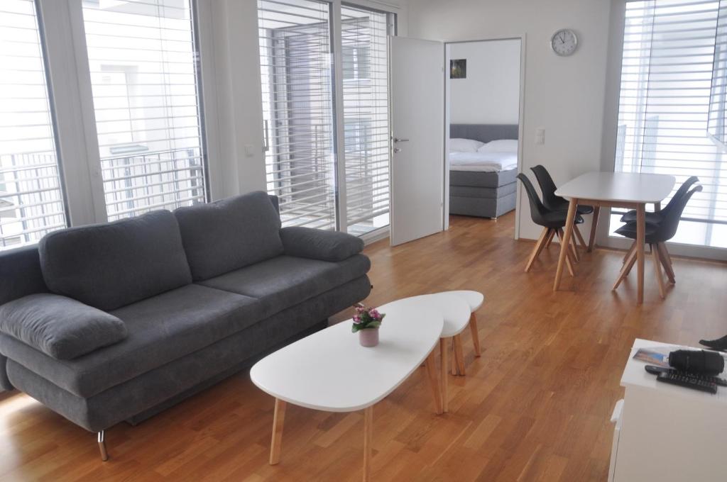 a living room with a couch and a table at 4 Beds and More Vienna Apartments - Contactless check-in in Vienna
