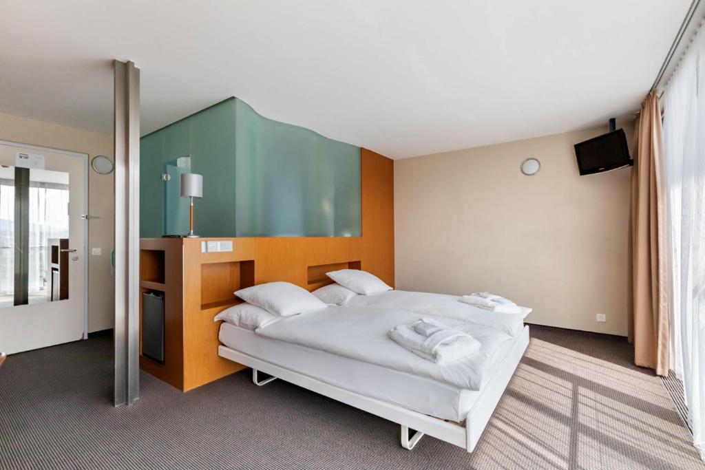 Postel nebo postele na pokoji v ubytování Hotel Cornavin