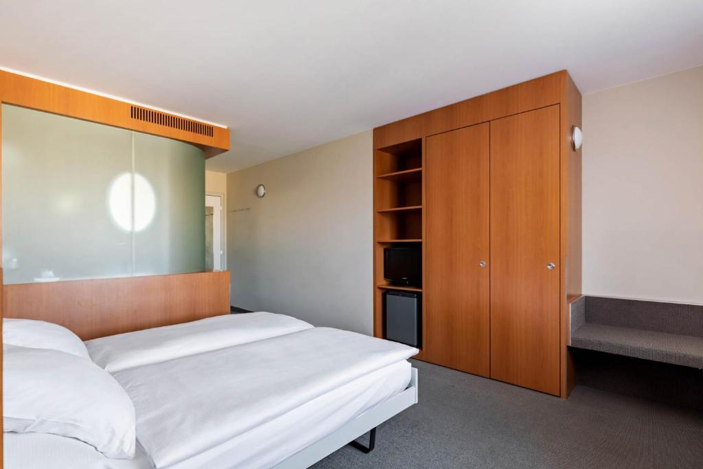 Postel nebo postele na pokoji v ubytování Hotel Cornavin
