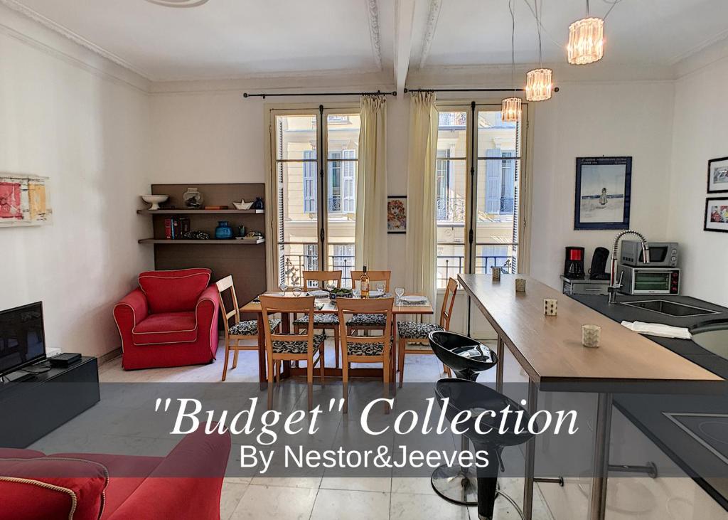 a living room with a red chair and a table at Nestor&Jeeves - DALPOZZO GRANDE - Central - Close beaches in Nice