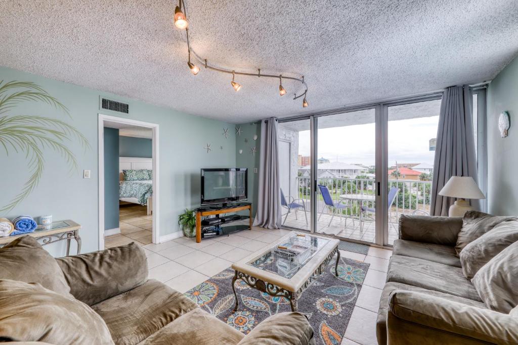 a living room with a couch and a tv at Dolphin Point in Destin