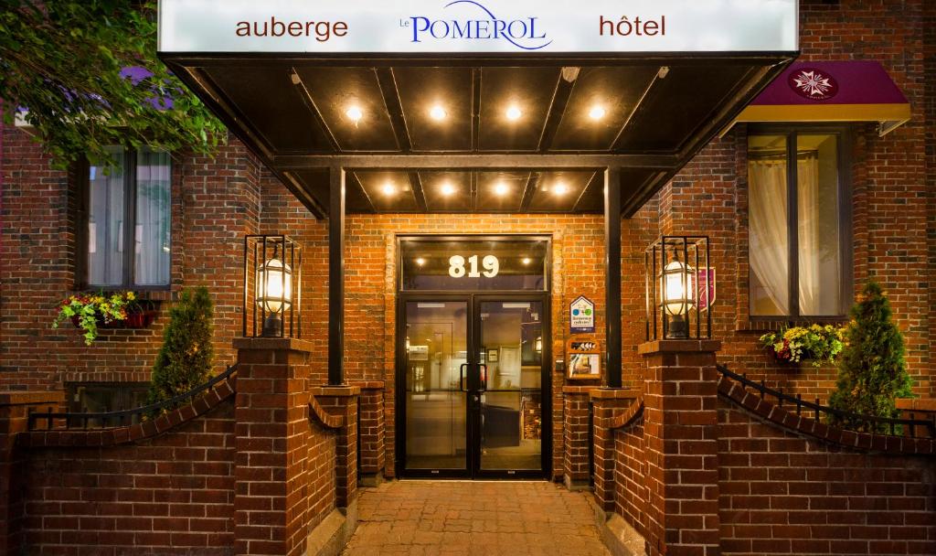 a entrance to a pomona hotel with a sign above the door at Auberge Le Pomerol in Montréal