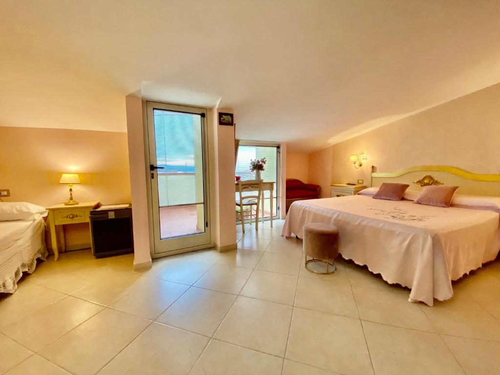 a bedroom with a bed and a view of the ocean at Hotel Scilla in Scilla