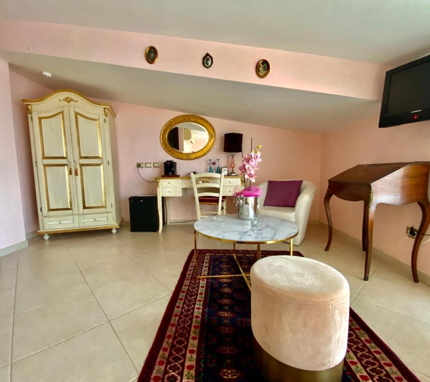 a living room with a piano and a table at Hotel Scilla in Scilla