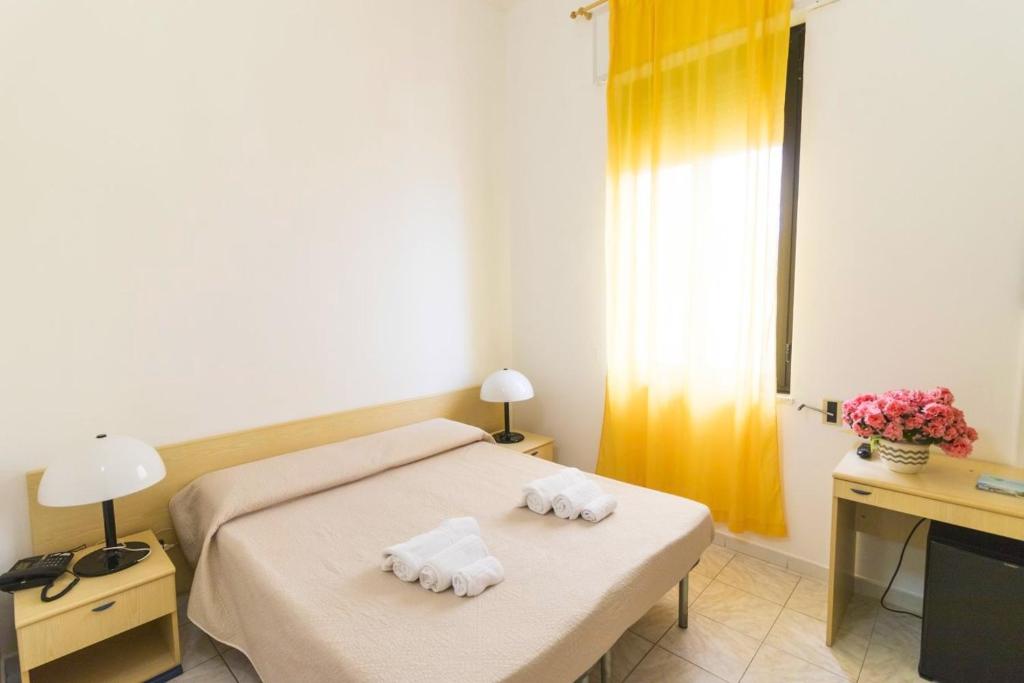 Postel nebo postele na pokoji v ubytování Albergo Palazzo