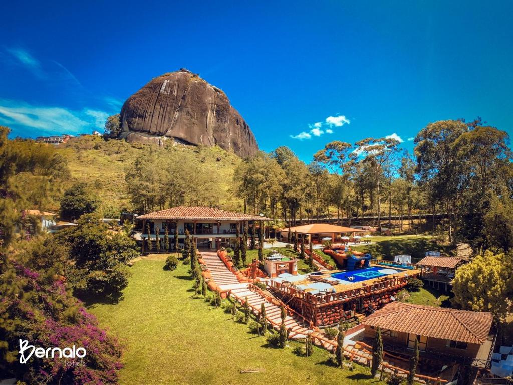 an aerial view of a resort with a rock in the background at Hotel Mansión Guatapé in Guatapé