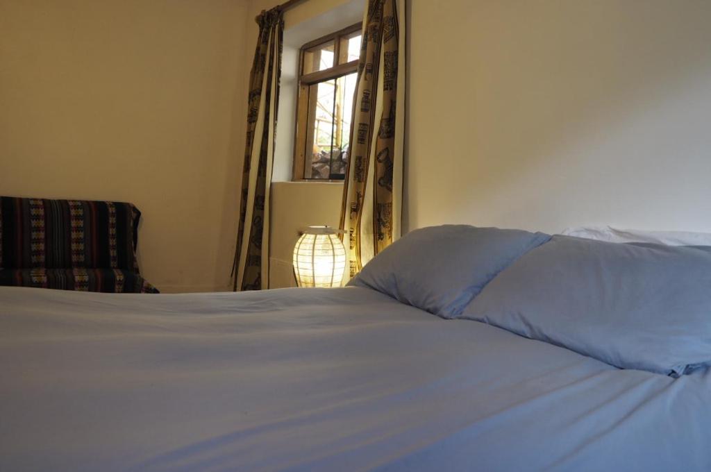 Postel nebo postele na pokoji v ubytování La Chakana Pisac