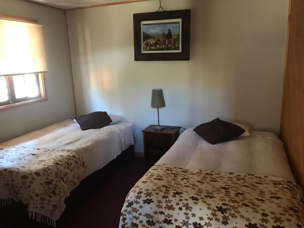Vuode tai vuoteita majoituspaikassa Apart Hotel y Cabañas Valle Exploradores