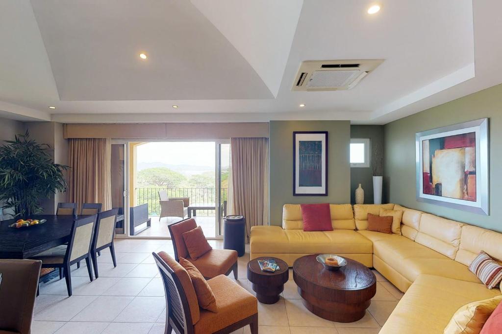 a living room with a couch and a table at Peninsula 64 Penthouse in Guanacaste