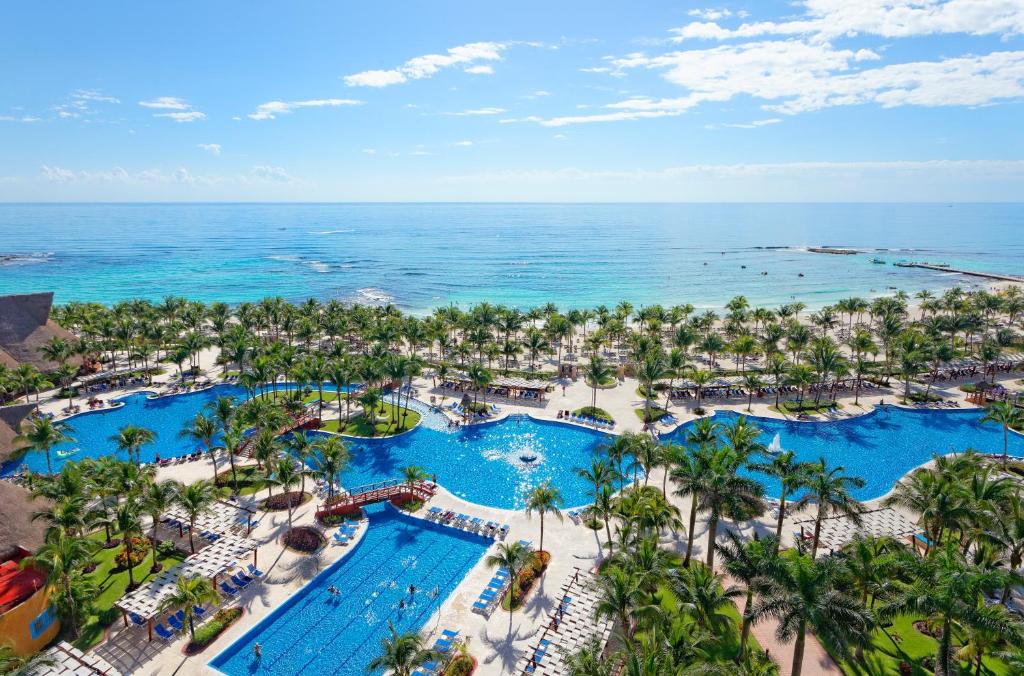 an aerial view of a resort with pools and the ocean at Barceló Maya Tropical - All Inclusive in Xpu Ha