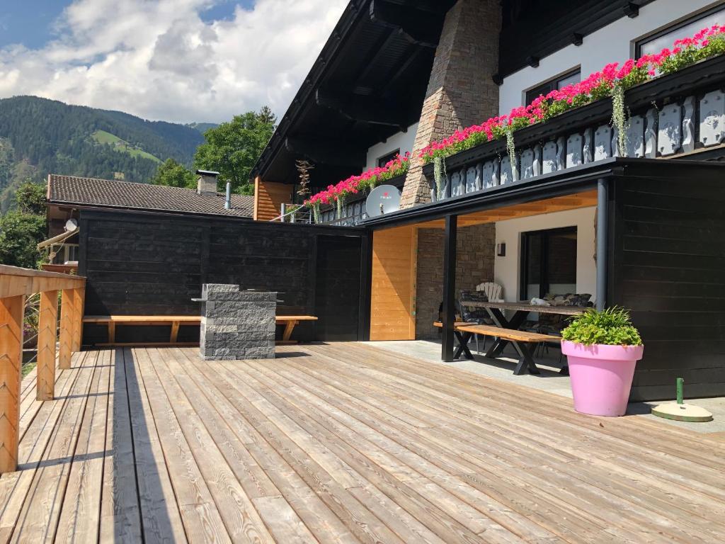a wooden deck with a table on a house at Landhaus Osttirol in Iselsberg