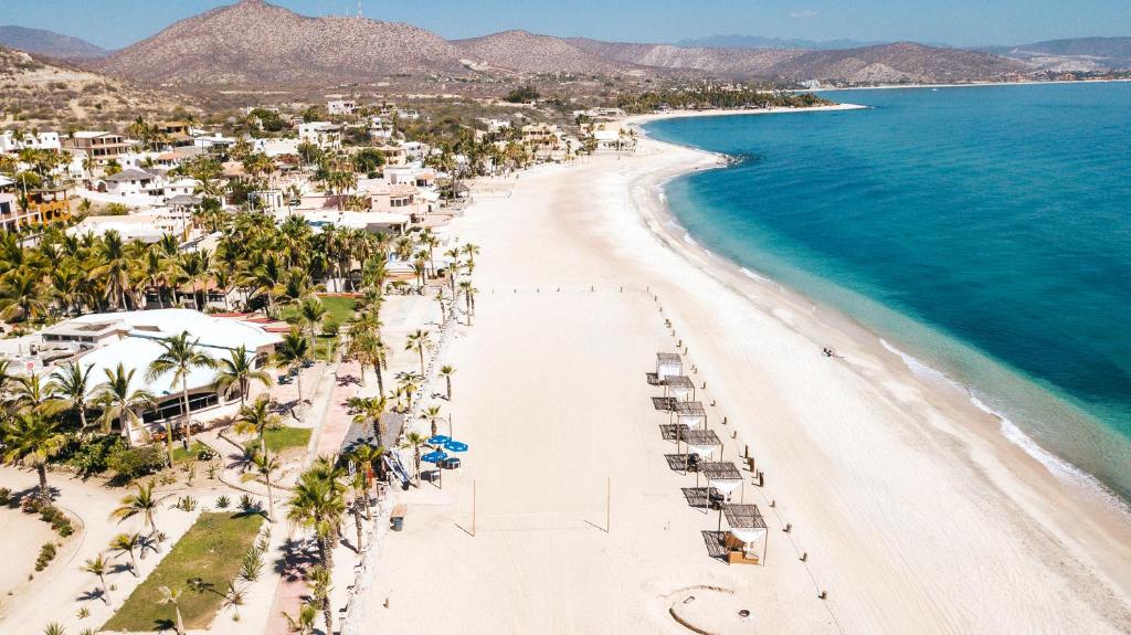 an aerial view of a beach with palm trees and the ocean at Buena Vista Oceanfront & Hot Springs Resort in Buenavista