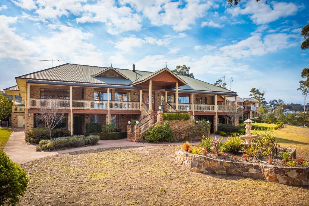 a large house with a large window overlooking a river at Robyns Nest in Merimbula