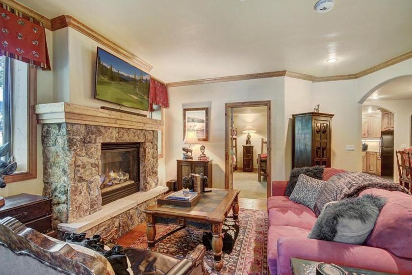 a living room with a couch and a fireplace at Cozy & Central Arrowhead Village Townhome Condo in Edwards