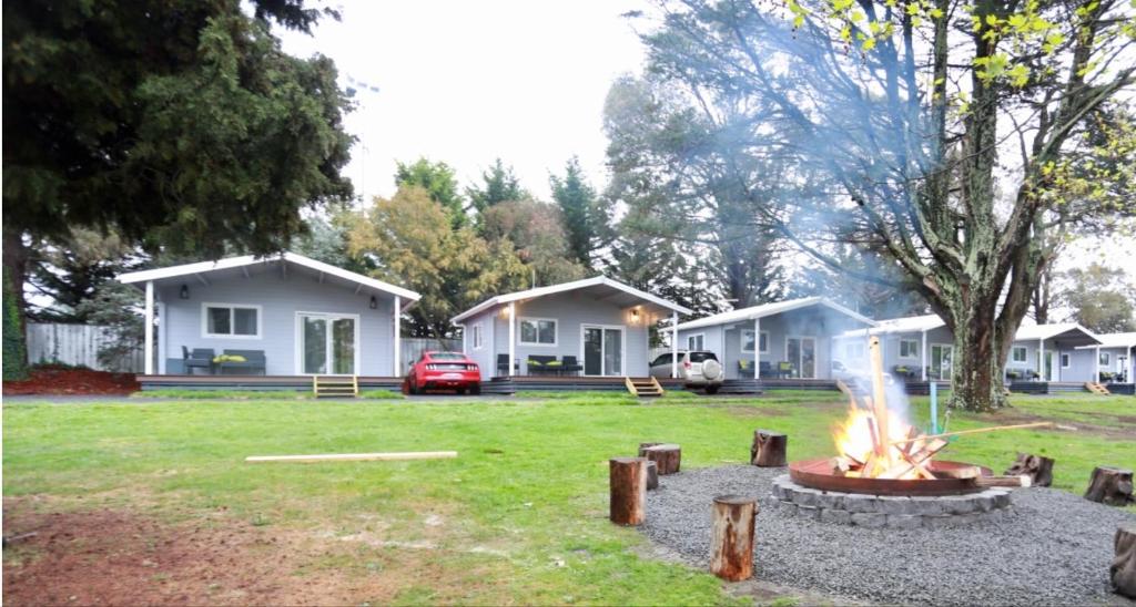 a group of houses with a fire in the yard at Jenolan Holiday Park Oberon in Oberon
