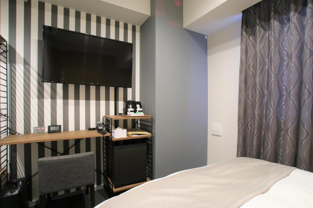 Postel nebo postele na pokoji v ubytování Hotel M's Est Shijo Karasuma