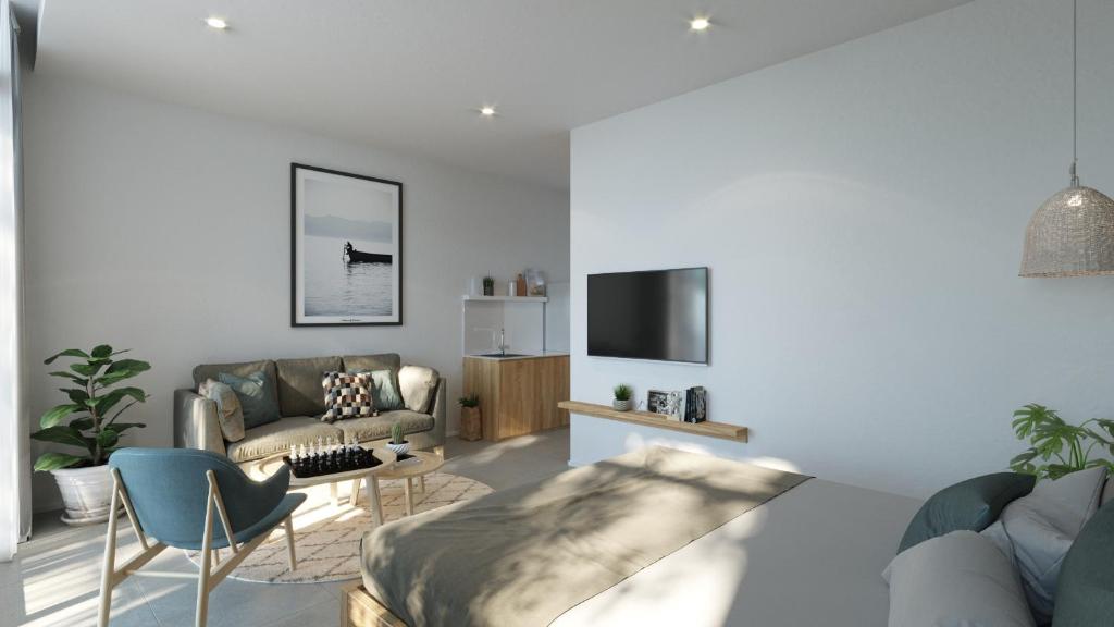 a living room with a couch and a tv at Lem's Apartment & Coffee in Da Nang