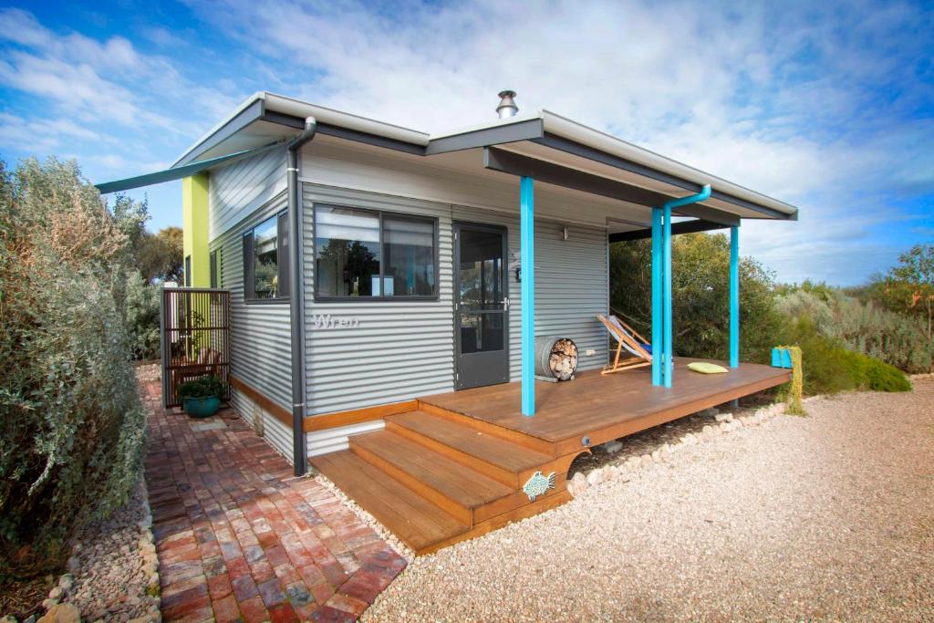 a tiny house with a large deck at Coorong Cabins in Meningie