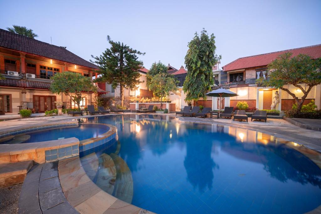 a large swimming pool in front of a building at Bendesa Accommodation in Kuta