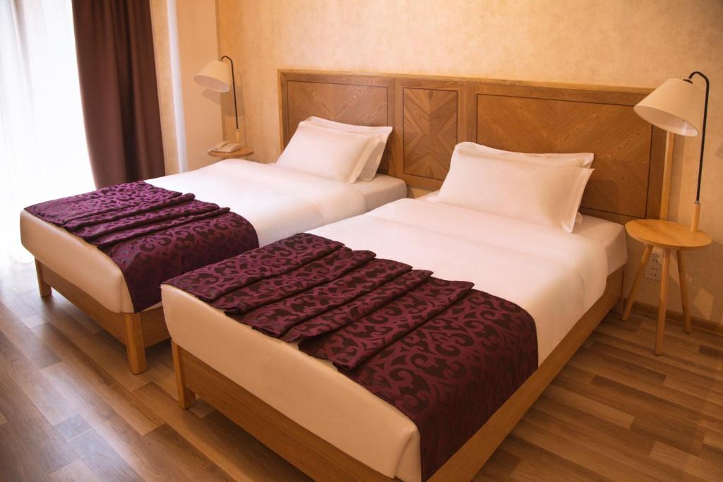 Postel nebo postele na pokoji v ubytování Ornament Boutique Hotel