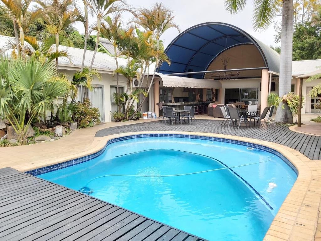 a swimming pool in front of a house at Rockview Lodge in Nelspruit