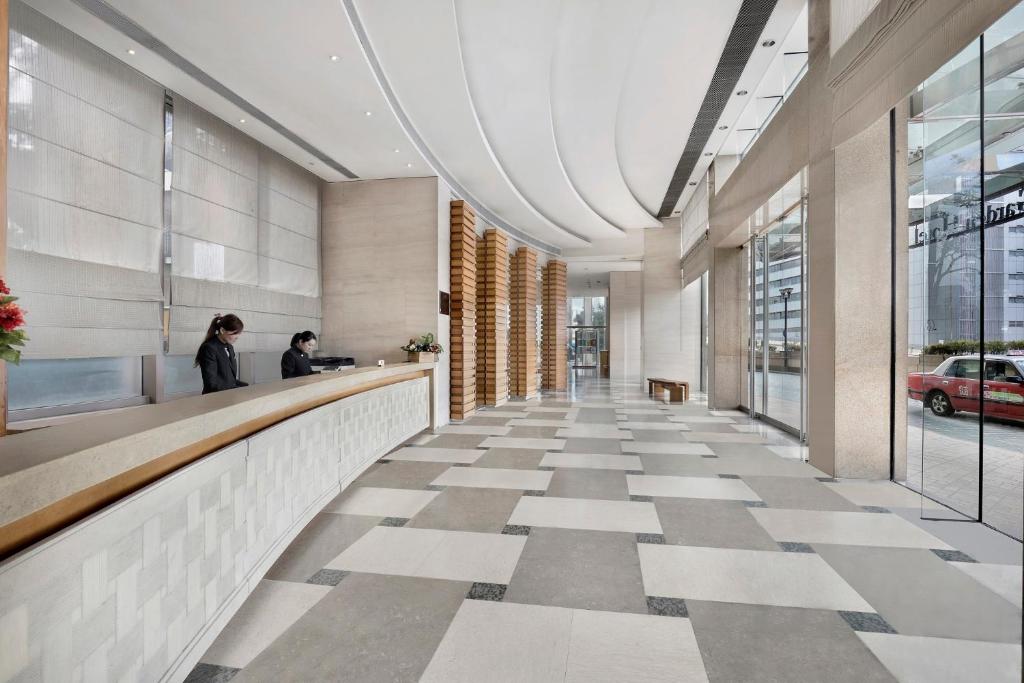 a lobby of a building with a checkered floor at Rambler Garden Hotel in Hong Kong