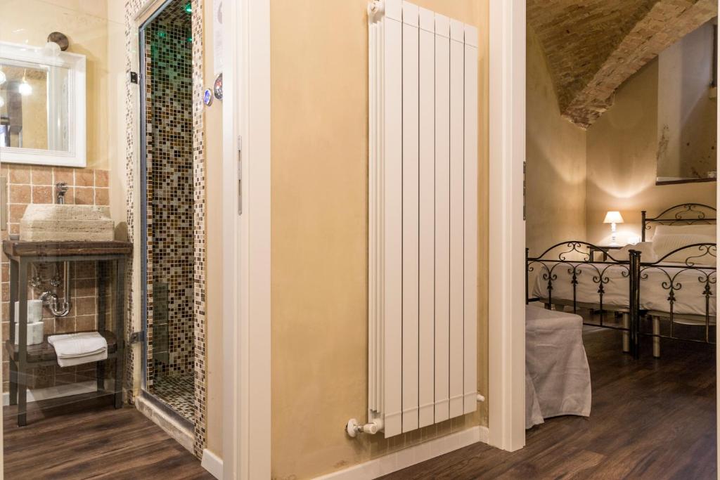 a room with a door leading into a room with a bedroom at la casa del vicolo - city center - in Perugia