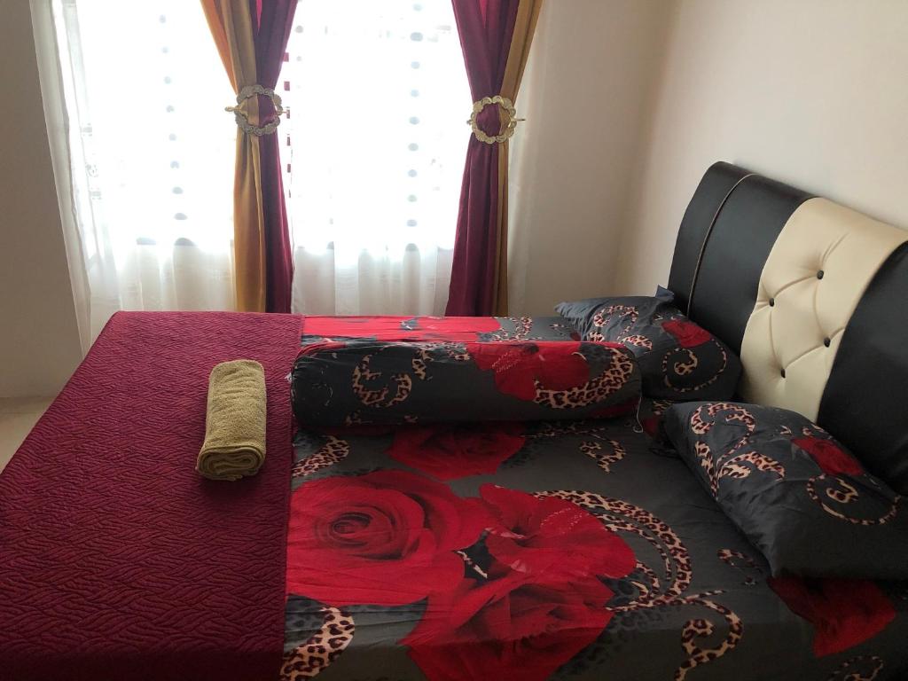 a couch with pillows on it with a blanket at Hasnifana Homestay Seri Iskandar in Seri Iskandar