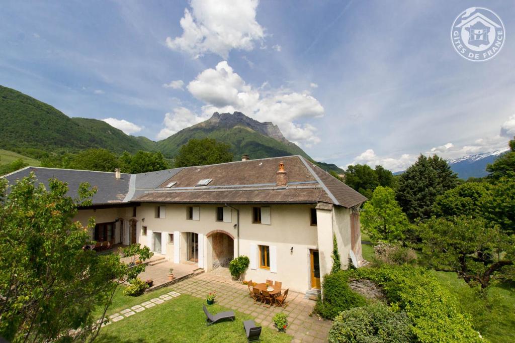 a house with a mountain in the background at GÎTE DU PORCHE in Saint-Jean-de-la-Porte