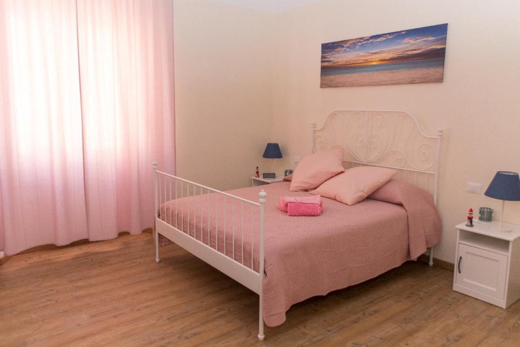 A bed or beds in a room at La Casa dei Nonni