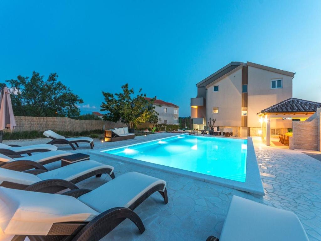 - une piscine avec des chaises longues à côté d'une maison dans l'établissement Modern Holiday Home in Pristeg with Pool, à Pristeg