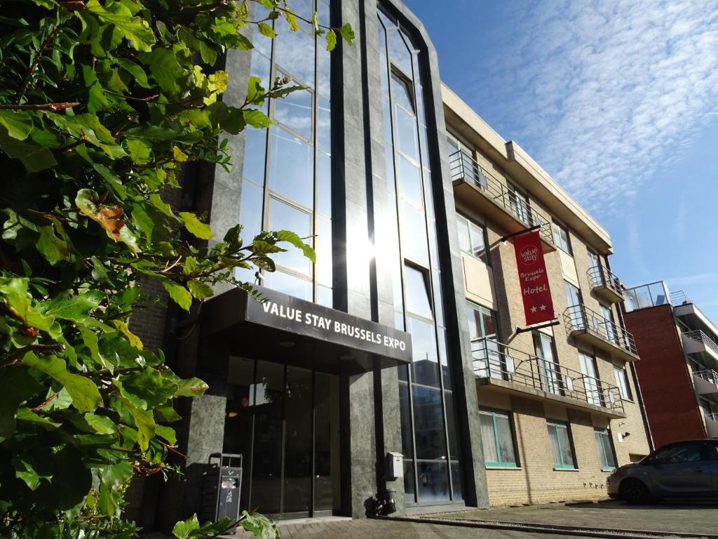 a building with a sign on the front of it at Value Stay Brussels Expo Hotel in Brussels