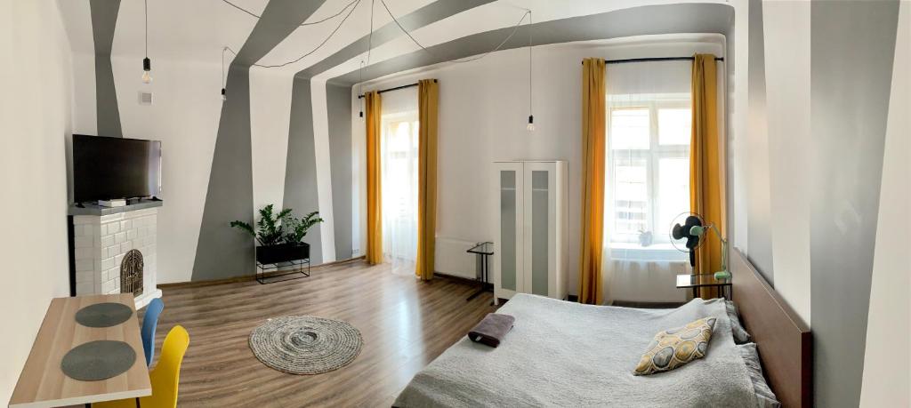 a living room with a bed and a tv at Apartament Równa 12 in Kielce