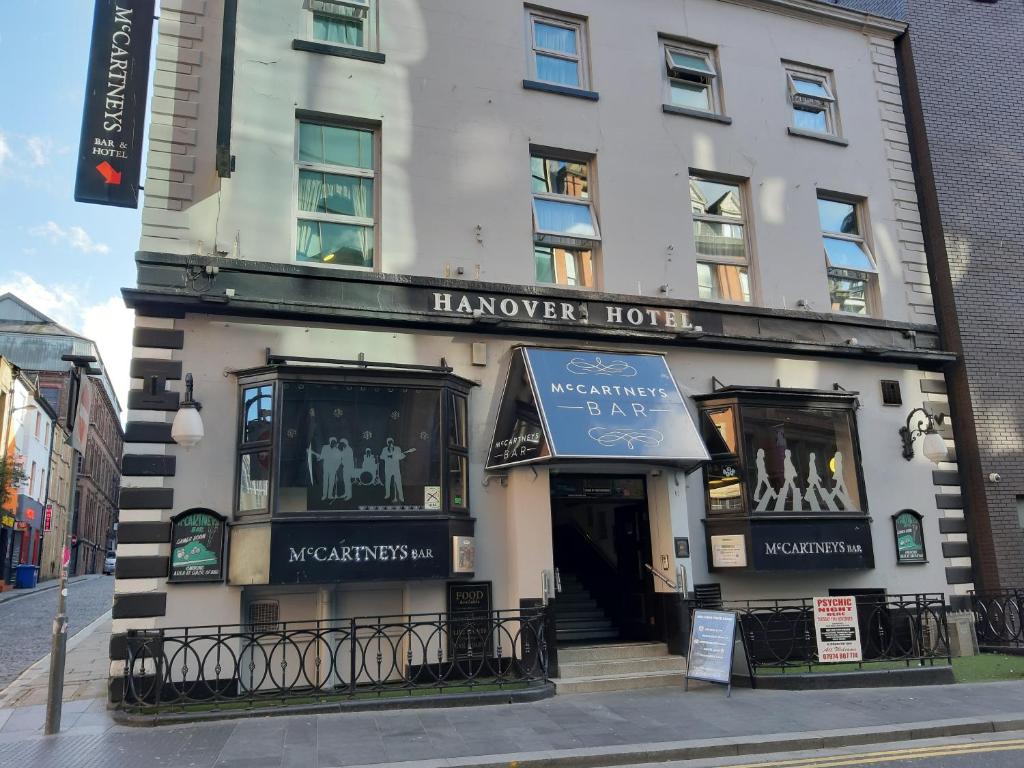 a building with a sign on the side of it at Hanover Hotel & McCartney's Bar in Liverpool