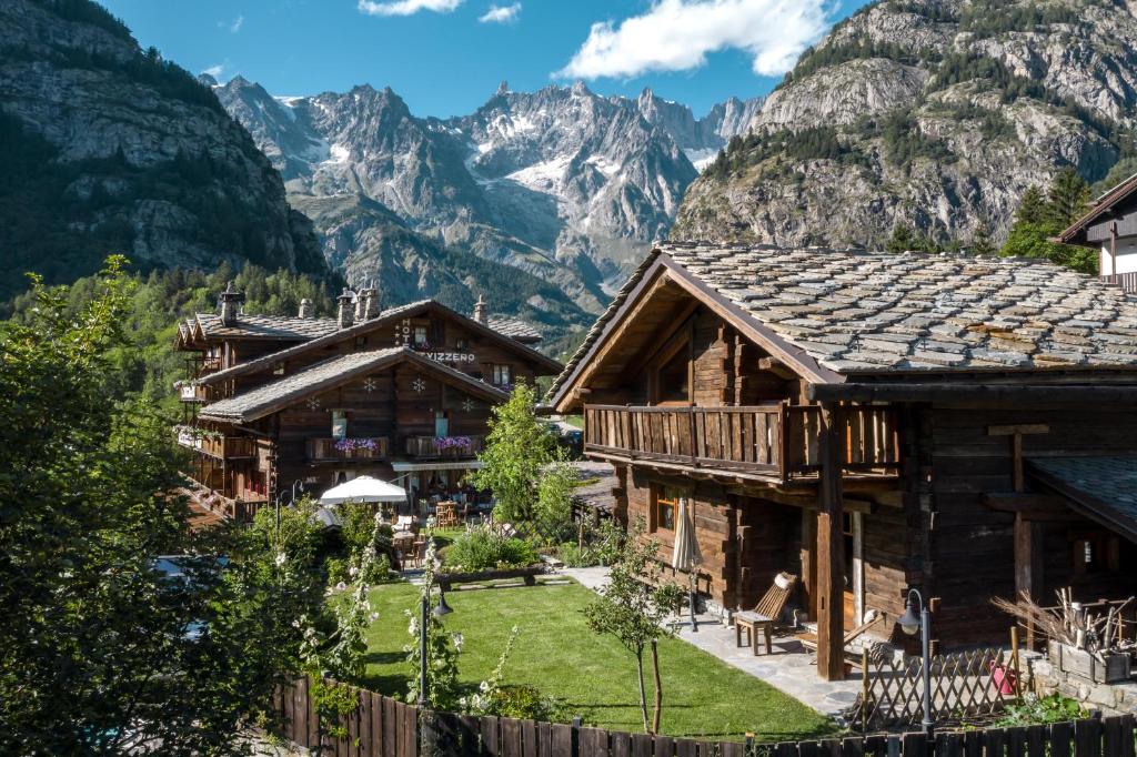 a mountain house with a view of the mountains at Chalet Svizzero Apartments in Courmayeur