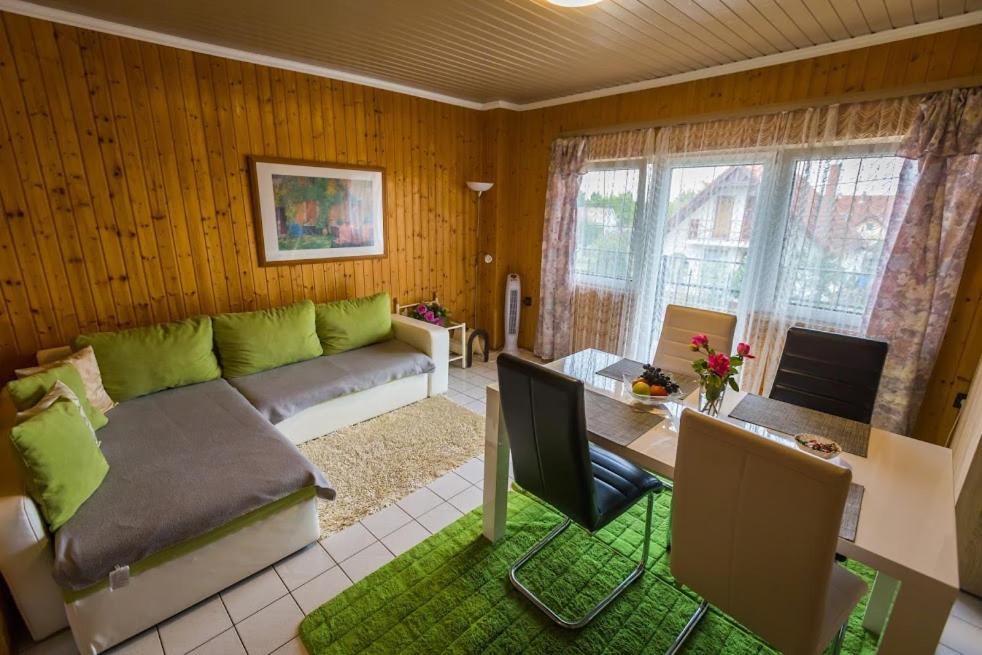 a living room with a couch and a table at Joli Guesthouse in Ordacsehi