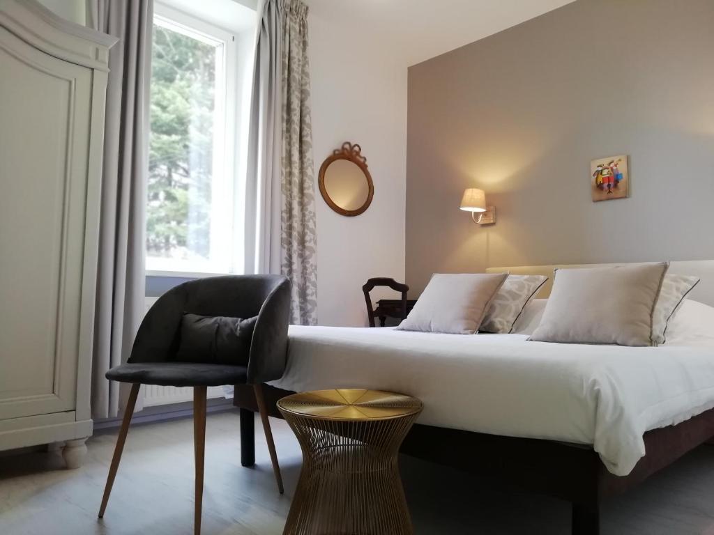 Ένα ή περισσότερα κρεβάτια σε δωμάτιο στο Le Domaine De Pairis